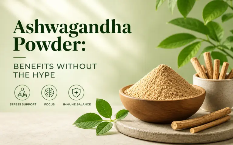 Ashwagandha powder in a wooden bowl with ashwagandha roots and green leaves, illustrating potential benefits for stress support, focus, and wellness.