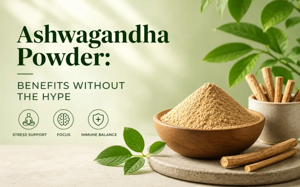 Ashwagandha powder in a wooden bowl with ashwagandha roots and green leaves, illustrating potential benefits for stress support, focus, and wellness.