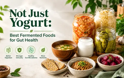 A variety of fermented foods for gut health, including yogurt, kimchi, sauerkraut, pickles, tempeh, miso soup, natto, and fermented beetroot, arranged in jars and bowls on a kitchen counter.